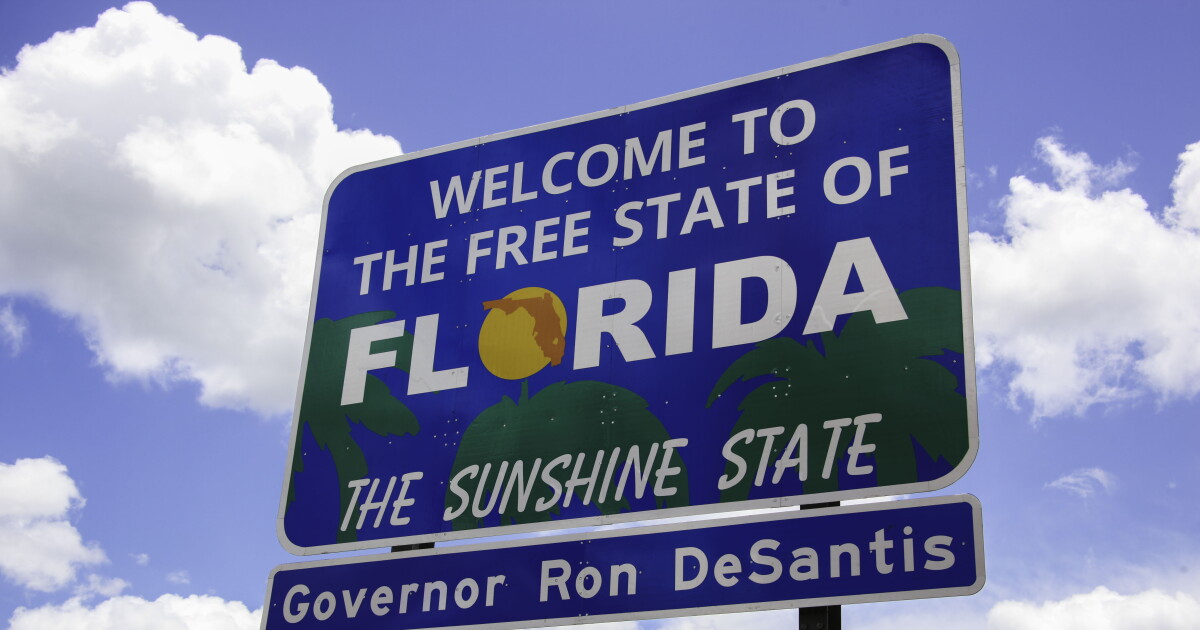Welcome to the Free State of Florida, the Sunshine State road sign